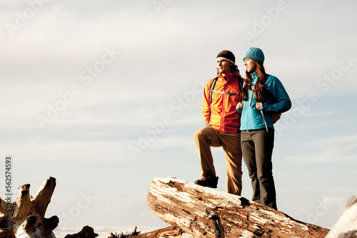 A couple day hiking along the rocky shore of Rialto Beach. photo