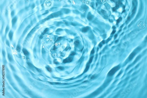 Closeup view of water with rippled surface on light blue background