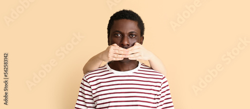 Person covering mouth of Af...