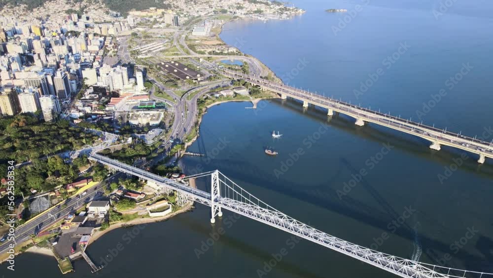 Drone aerial scene of hercilio luz Pedro Ivo Campos and Colombo Salles bridge in Florianópolis, capital of Santa Catarina, with intense vehicle traffic, scene at high altitude with urbanism