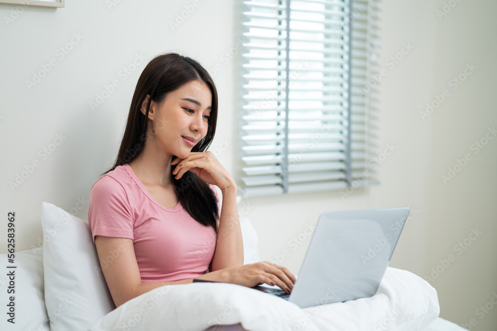 Beautiful Asian young businesswoman typing laptop keyboard in house. Beautiful Asian young businesswoman typing laptop keyboard in house.