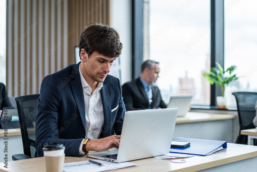 Exhausted Caucasian businessman using laptop computer work in office. Exhausted Caucasian businessman using laptop computer work in office.