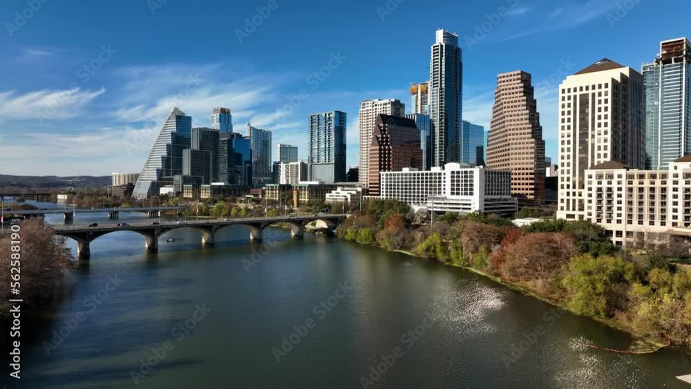 Aerial view low over the river, towards high-rise, sunny, fall day in Austin, USA Aerial view low over the river, towards high-rise, sunny, fall day in Austin, USA
