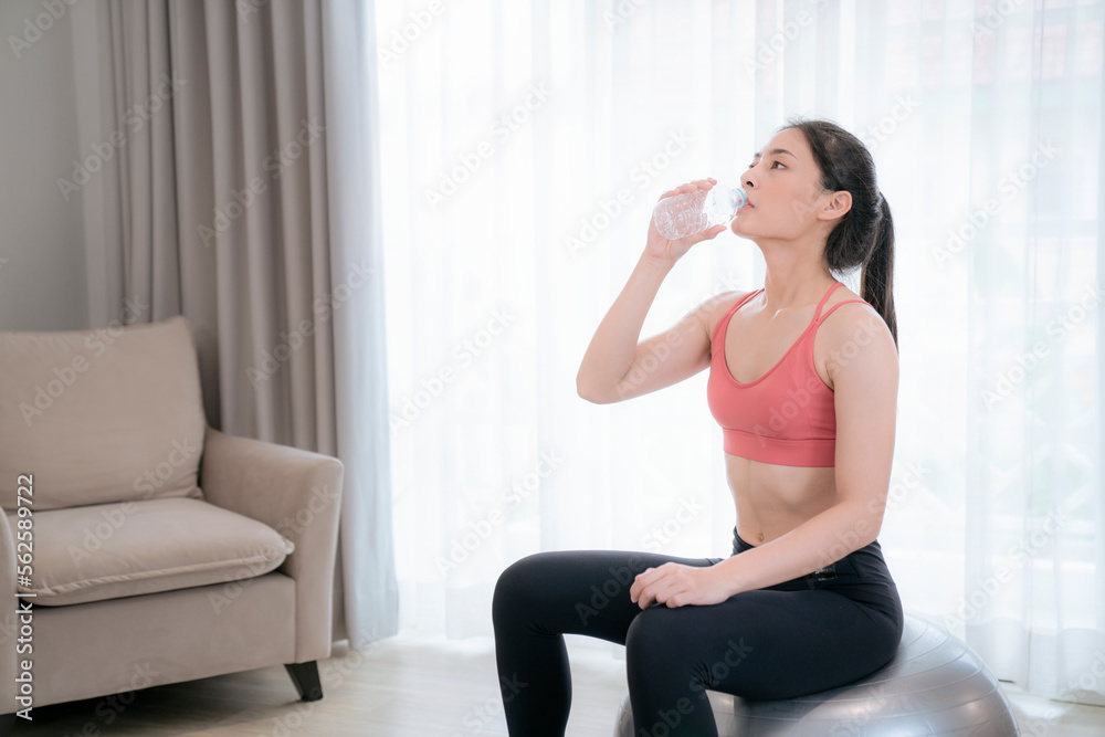 Asian woman exercise and stretching in her bed room, her try to make slim by take Yog Asian woman exercise and stretching in her bed room, her try to make slim by take Yog