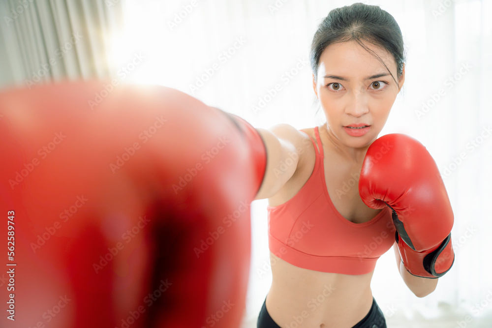 Asian woman exercise and boxing in her bed room