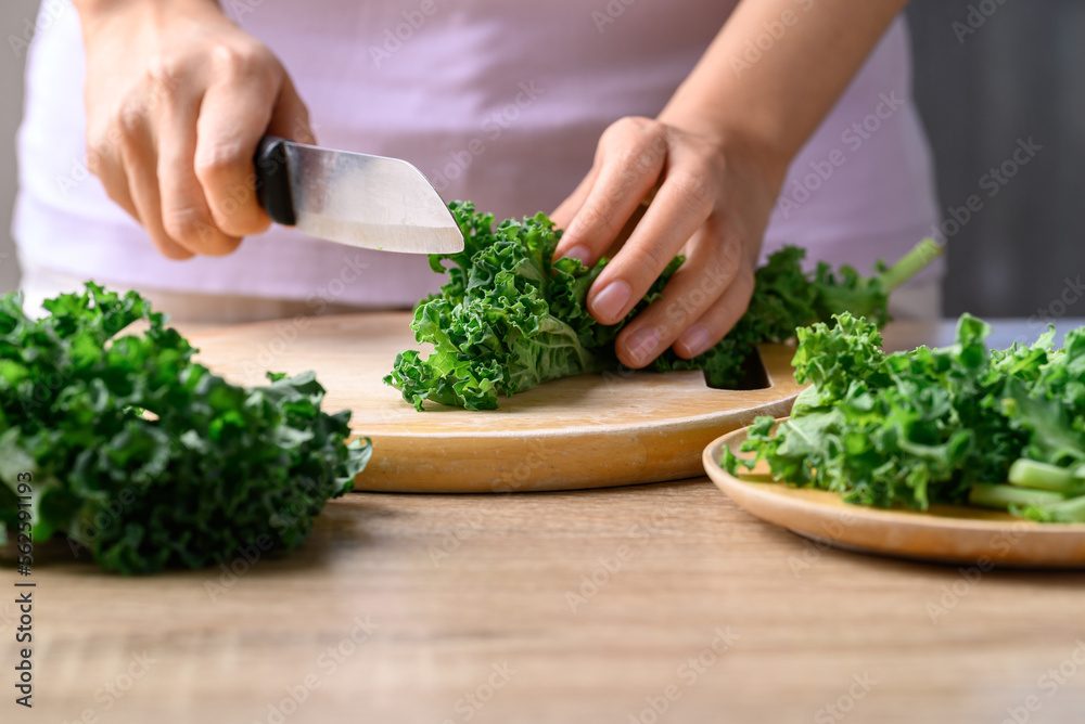 Green Kale or leaf cabbage cutting on wooden board, Healthy vegetable