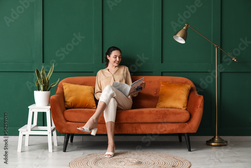Young woman reading magazin...