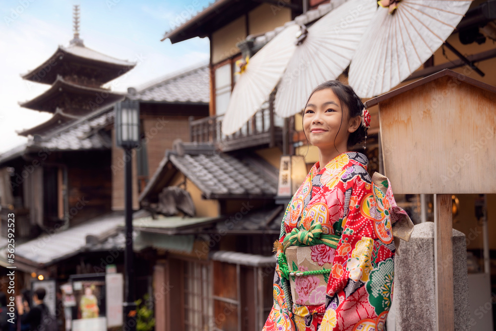 Japanese tourist girl in red Kimono traditional dress walking in walking street at Gion Temple area Japanese tourist girl in red Kimono traditional dress walking in walking street at Gion Temple area