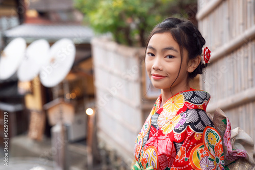 Japanese tourist girl in red Kimono traditional dress walking in walking street at Gion Temple area © anekoho