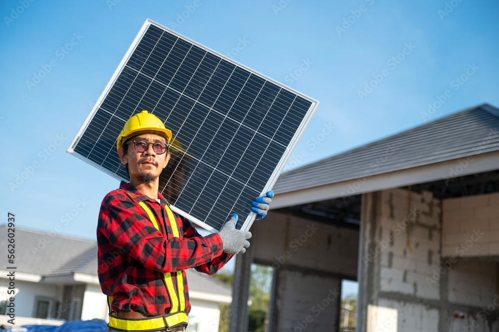 Technicians carrying solar panels ready to be installed on the roof of a housing estate energy-saving and cost-saving concept Own a small business installing solar panels. Technicians carrying solar panels ready to be installed on the roof of a housing estate energy-saving and cost-saving concept Own a small business installing solar panels.