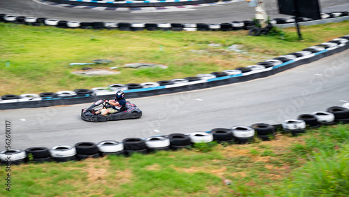 A man rides in the picture among the tires in motion