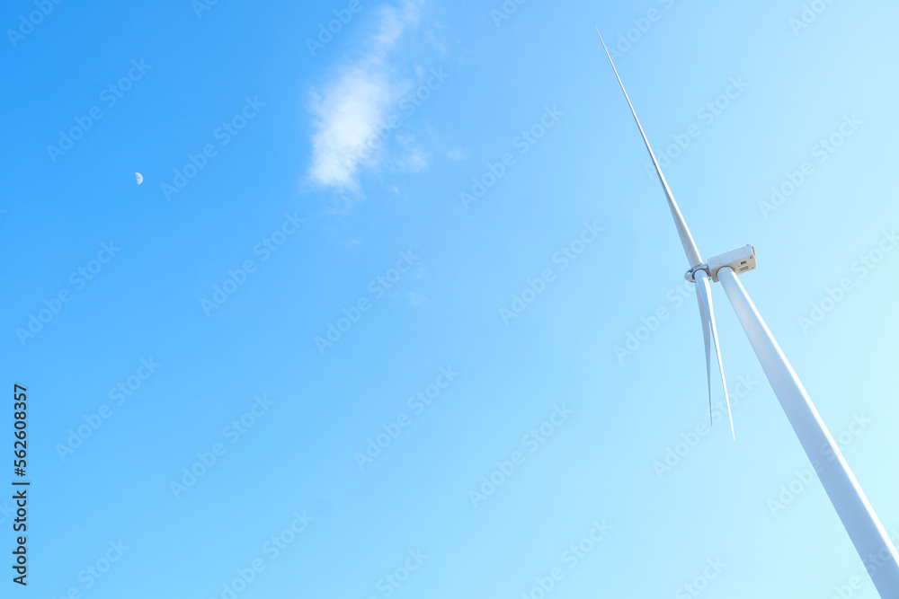 Wind farm on the mountain. Lonely windmill on a beautiful sunny day. Wind energy concept, alternative energy, renewable energy Wind farm on the mountain. Lonely windmill on a beautiful sunny day. Wind energy concept, alternative energy, renewable energy