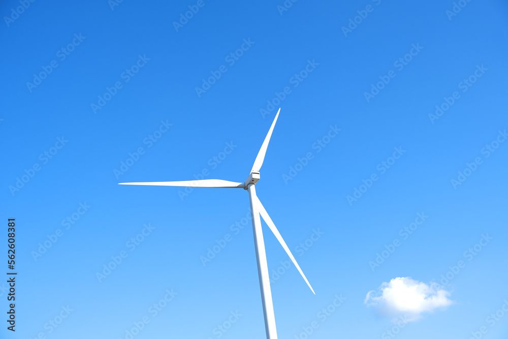 Wind farm on the mountain. Lonely windmill on a beautiful sunny day. Wind energy concept, alternative energy, renewable energy Wind farm on the mountain. Lonely windmill on a beautiful sunny day. Wind energy concept, alternative energy, renewable energy