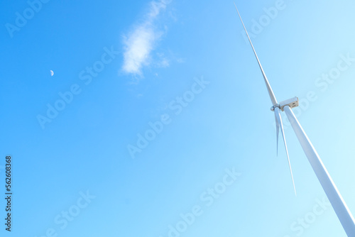 Wind farm on the mountain. Lonely windmill on a beautiful sunny day. Wind energy concept, alternative energy, renewable energy