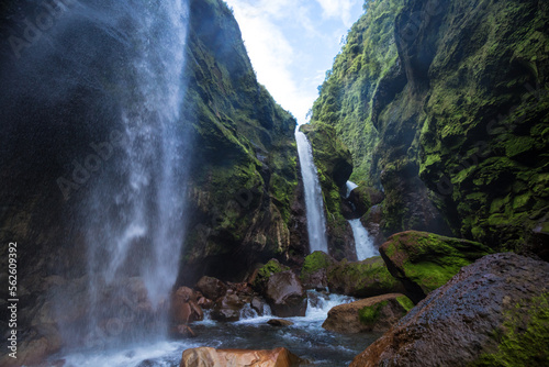 paroramic shot of three waterfalls falling into the riverbed in the middle of the tropical jungle of Costa Rica