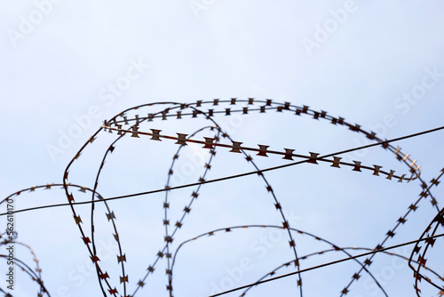 Barbed wires against sky. Wired fence