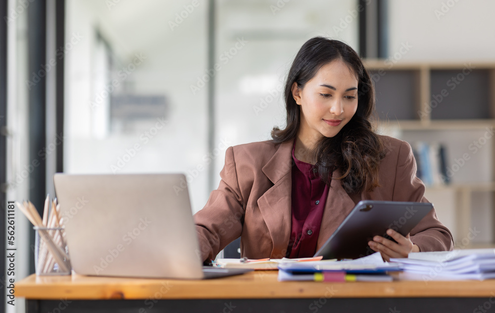 Freelancer Happy business Asian woman in knitwear taking notes at laptop sitting at desk office, finance concept.
Freelancer Happy business Asian woman in knitwear taking notes at laptop sitting at desk office, finance concept.
