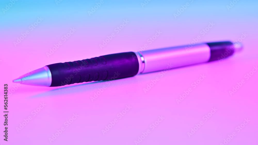 4K Video of mechanical pencil with pink light.