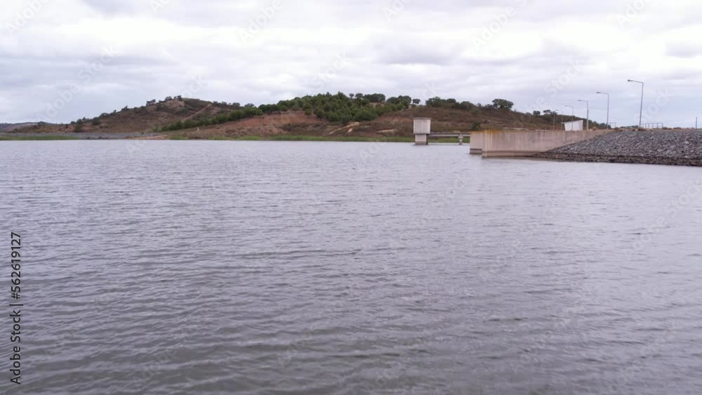 Aerial flyover reservoir lake water surface on cloudy day, Alentejo Aerial flyover reservoir lake water surface on cloudy day, Alentejo