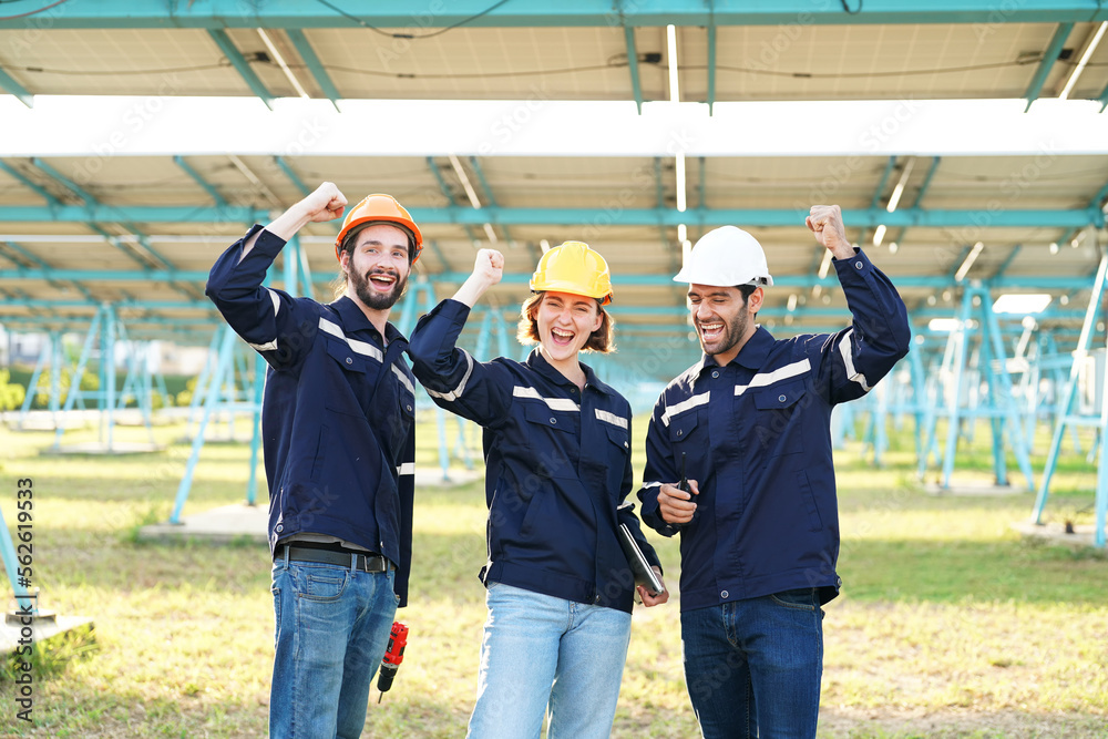 Specialist technician team is checking with tablet an operation of sun and cleanliness on field of photovoltaic solar panels on a daytime. Specialist technician team is checking with tablet an operation of sun and cleanliness on field of photovoltaic solar panels on a daytime.