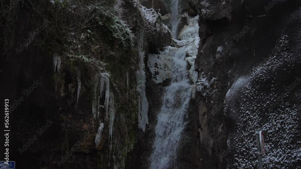 Clip of a frozen waterfall filmed in Europe in Austria from a town called Hallstatt . Filmed at winter time in December with everything covered in snow, foggy weather.In 4k with a smooth movement Clip of a frozen waterfall filmed in Europe in Austria from a town called Hallstatt . Filmed at winter time in December with everything covered in snow, foggy weather.In 4k with a smooth movement
