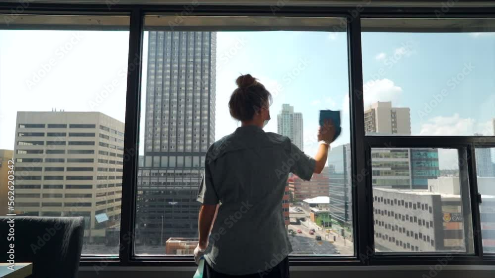 The maid efficiently goes about her tasks, tidying up the hotel room with precision and care, by wiping and cleaning everything in a hotel room. The maid efficiently goes about her tasks, tidying up the hotel room with precision and care, by wiping and cleaning everything in a hotel room.