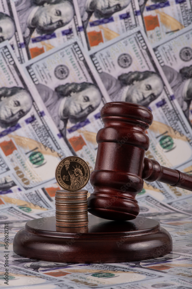 Judge's gavel against the background of 100 US dollar bills Judge's gavel against the background of 100 US dollar bills