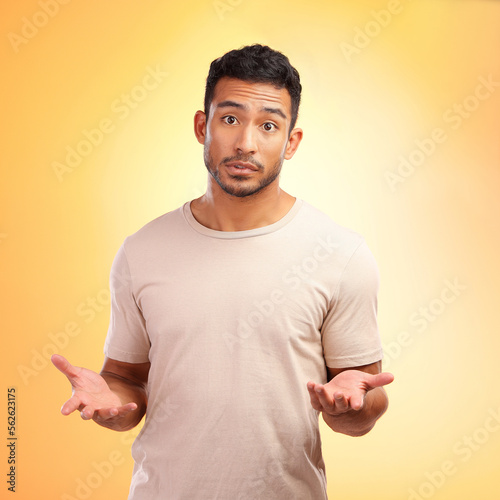 Man, confused and hands out isolated with questions and asking why on yellow background with mockup. Confusion, doubt and person from India with problem and frustrated hand gesture in studio portrait