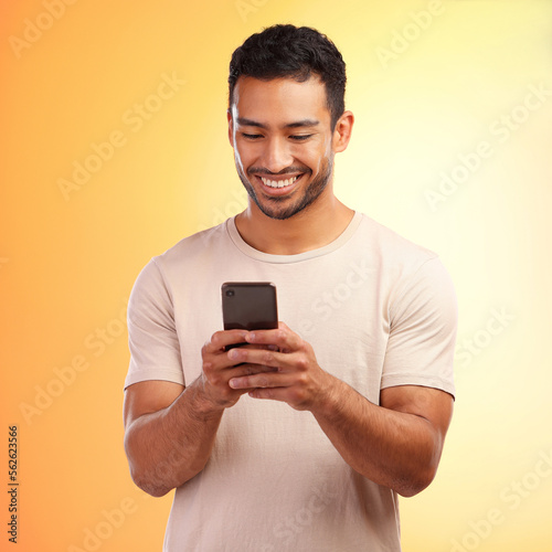Man, studio and phone for social media, chat and online dating with smile, reading and happiness. Model, smartphone communication and texting app on social network ui and digital contact on internet © Courtney/peopleimages.com