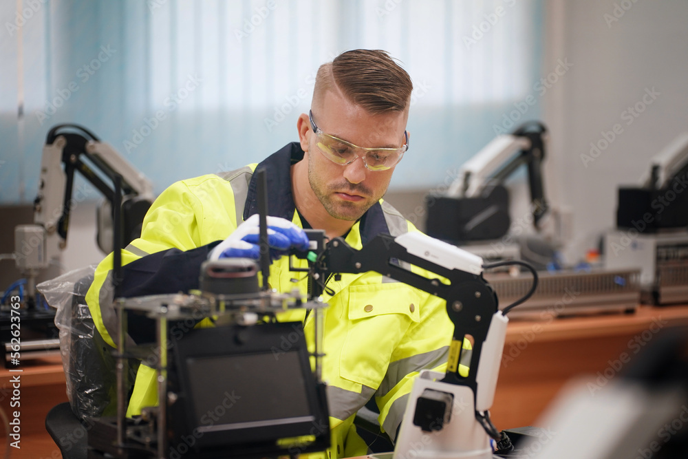 Engineers working on development of automated production line with robotic parts and applied software in order to increase productivity. Precise engineering on electric parts of automated production . Engineers working on development of automated production line with robotic parts and applied software in order to increase productivity. Precise engineering on electric parts of automated production .