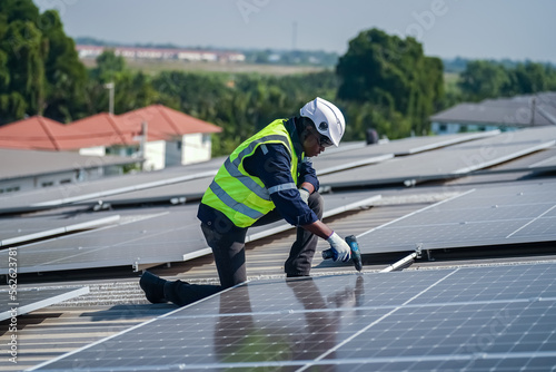 Wallpaper Mural Well-equipped worker in protective clothing working and examining solar panels on a photovoltaic rooftop plant. Concept of maintenance and installation of solar station. Torontodigital.ca