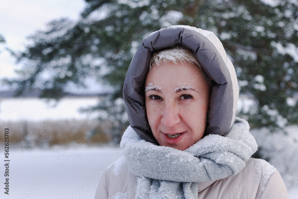 Portrait of happy beautiful elderly senior retired woman in age is playing, having fun with snow outdoors in forest or park at winter cold day, smiling, enjoy weather Portrait of happy beautiful elderly senior retired woman in age is playing, having fun with snow outdoors in forest or park at winter cold day, smiling, enjoy weather