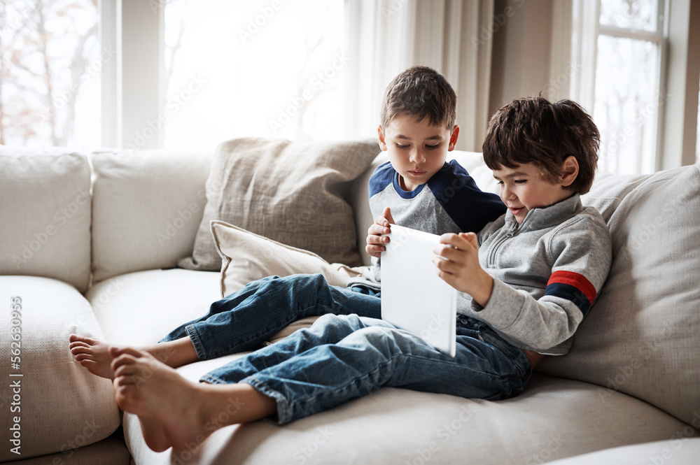 Boys, bonding or tablet for movie streaming, social media, or esports gaming on family home sofa or living room. Kids, brothers or children on digital technology on education learning support or help