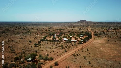 Panoramic drone shot approaching an African village in Karamoja, also called Manyattas in Uganda on a sunny day. High quality 4k footage. photo