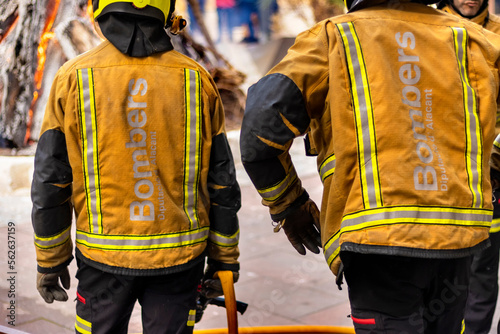 A firefighters carrying an accident victim from a fire