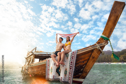 Asian couple lover travel and relax in they honeymoon trip on the wooded boat photo