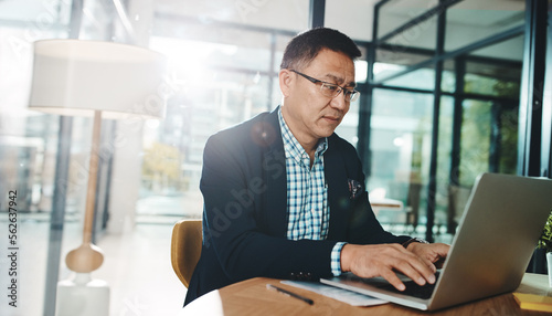 Office laptop, typing and Asian man reading feedback review of social media, customer experience or ecommerce website. Data analytics, infographic and marketing employee analysis of online survey
