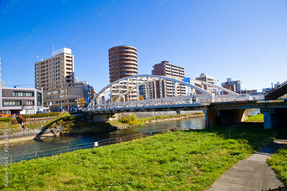 Mount Iwate scene with buildings and promenade at Katakami river in  Morioka city, Iwate prefecture, Tohoku, Japan.