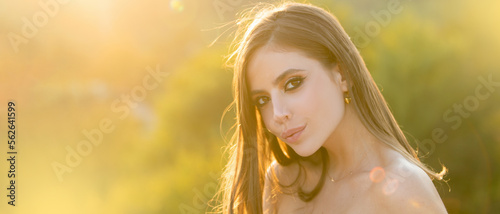 Beautiful young woman, tender girl. Fashion and beauty. Young woman on sunny spring day. Spring woman on sunlight romantic portrait, sensual sunny face. Banner for website header. photo