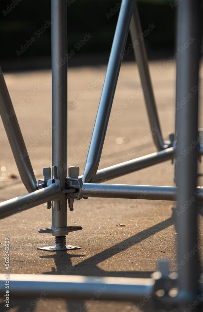 Scaffolding for a small sport stadium made from metal poles. Close-up in details of joint connecting.