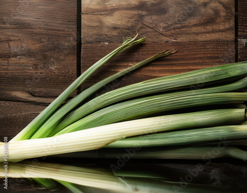Food photo of a leeks on wooden table with copy space, Exotic Winter Fruit & Leeks and Green Onions Month - AI Generated