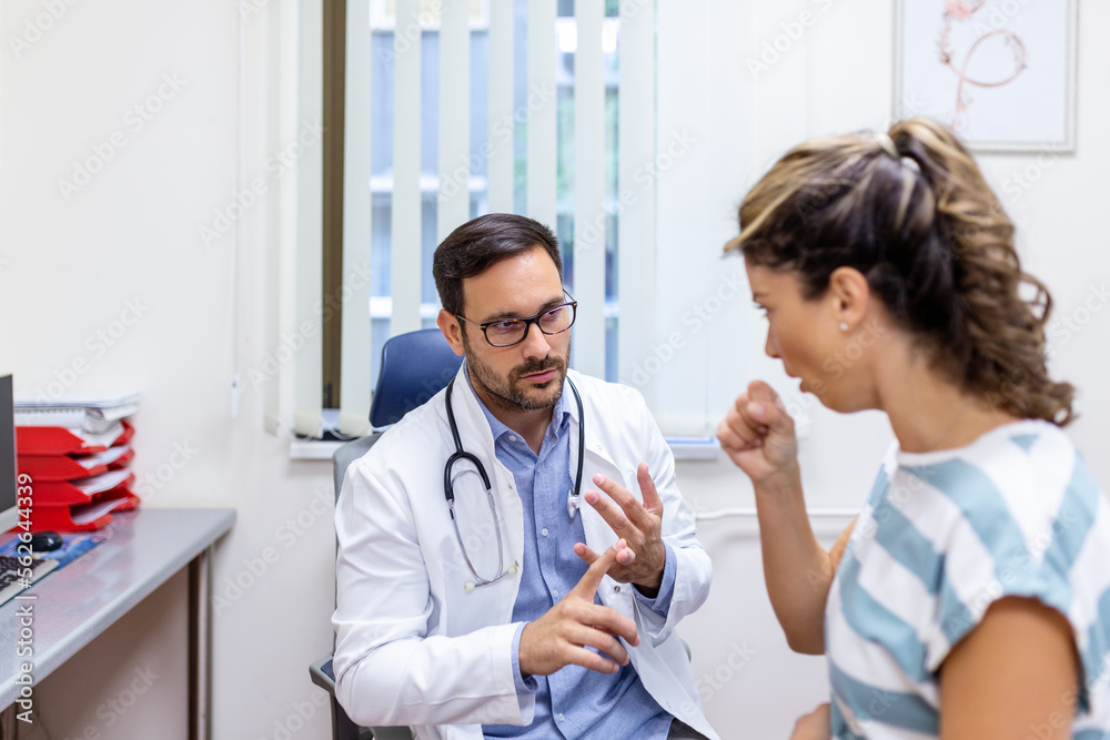 Fototapeta premium Coughing woman visiting doctor at clinic, patient coughing at medical appointment with her doctor. Sick woman visiting doctor at the hospital.