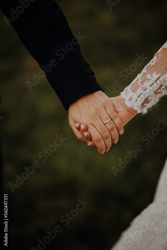 Bride and groom holding their hands 