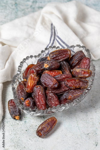 Date fruit on stone background. Organic Medjoul dates in a glass bowl. Ramadan food. close up photo