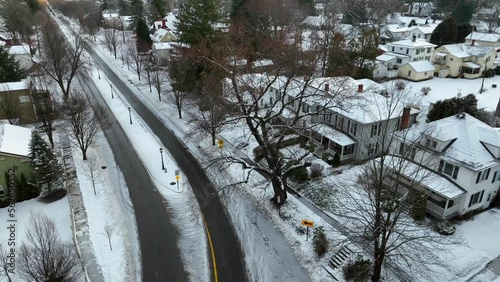 Slow aerial tilt up reveal of snowy ski town in winter after snow storm. photo