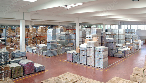 storage and shipping warehouse full of packed pallets and cartons
