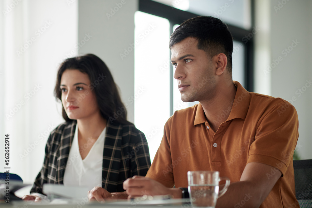 Serious young couple meeting with insurance agent in office Serious young couple meeting with insurance agent in office