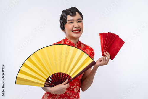 Beautiful Asian woman wearing cheongsam holding gold fan and red envelope isolated on white background, Happy Chinese New Year.