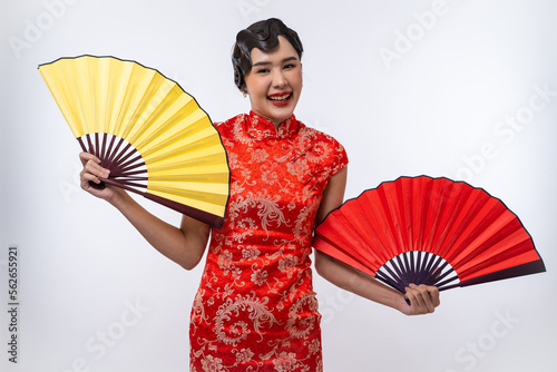 Beautiful Asian woman wearing cheongsam with gold and red fans isolated on white background, Happy Chinese New Year.