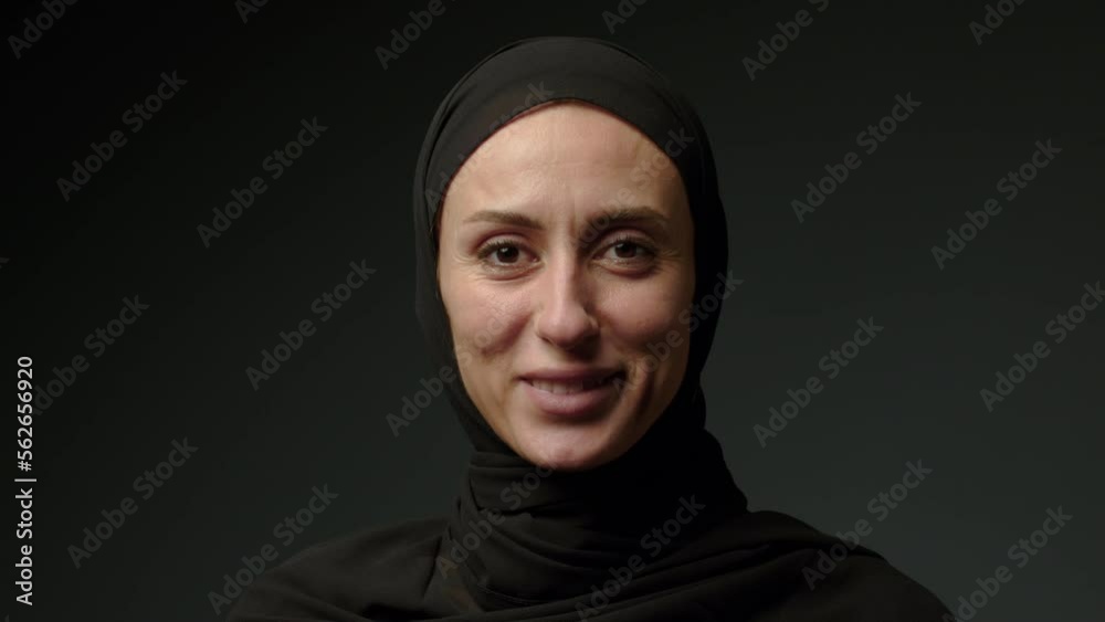 Face with natural make up of attractive muslim girl wearing traditional hijab scarf. Her brown eyes looking at camera, islam concept extreme close up 4k footage Face with natural make up of attractive muslim girl wearing traditional hijab scarf. Her brown eyes looking at camera, islam concept extreme close up 4k footage